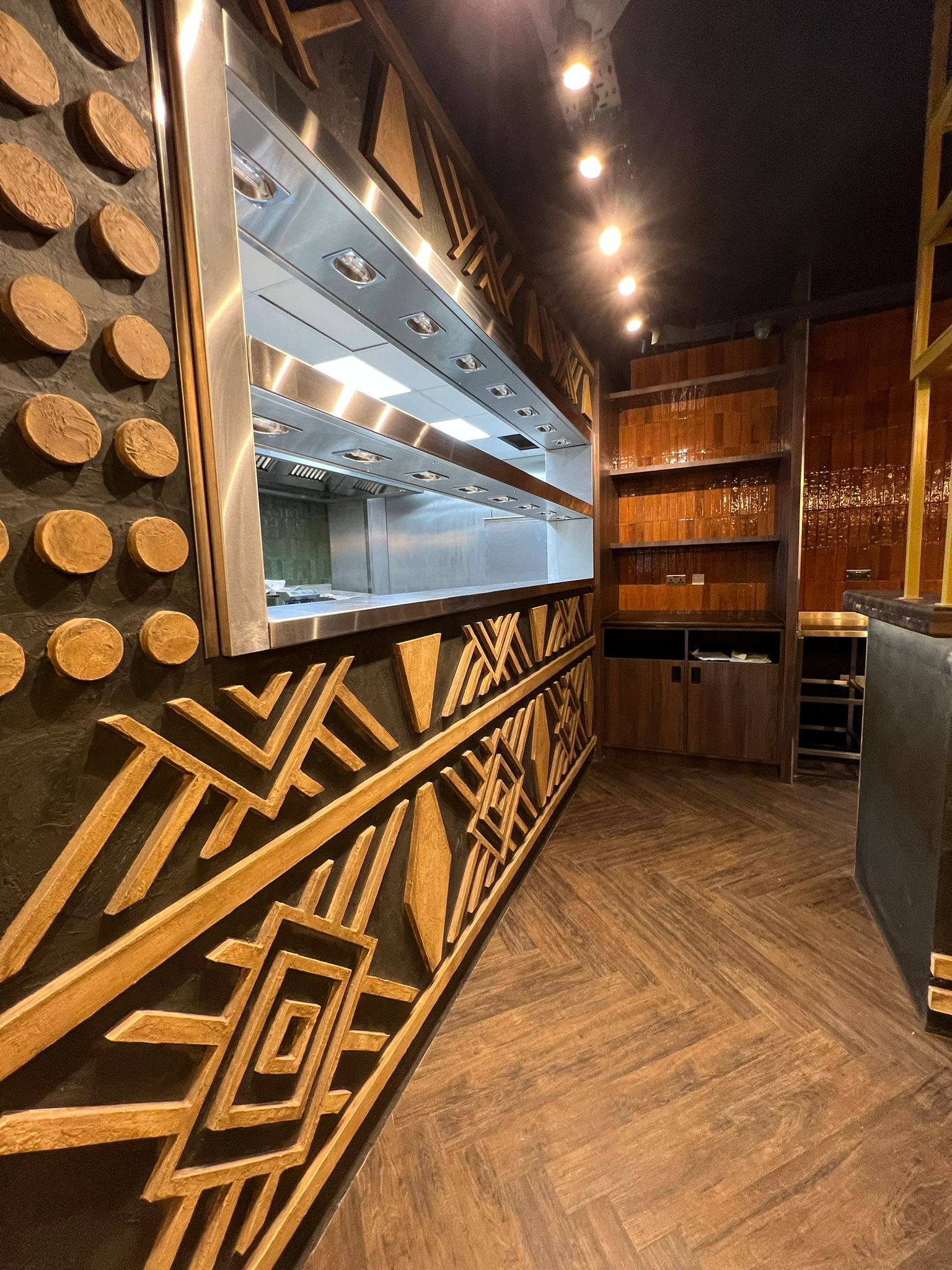 Kitchen pass with patterned timber joinery
