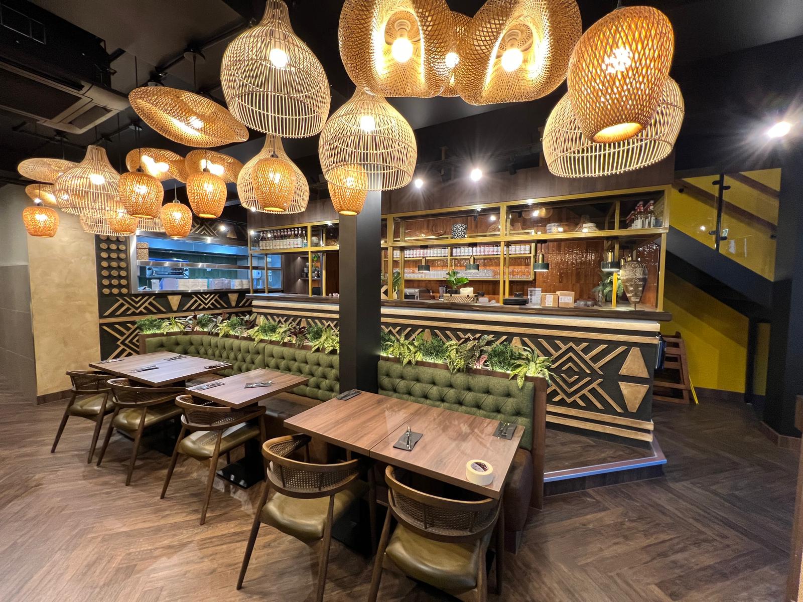 Afrikana restaurant dining area with rattan pendants